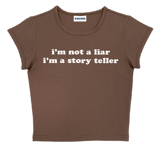 i'm not a liar i'm a story teller baby tee