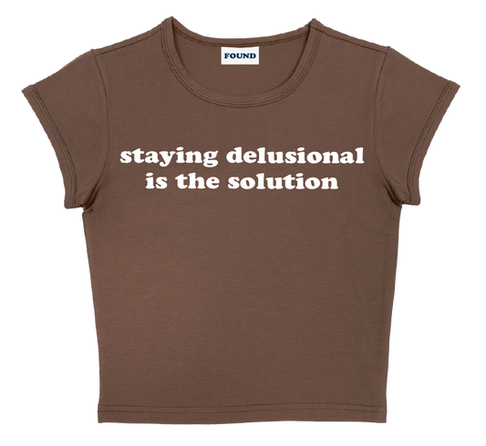 staying delusional is the solution baby tee